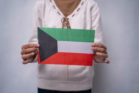 Hands Holding Flag of the Nation Kuwaitの写真素材