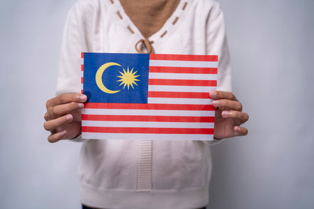 Hands Holding Flag of the Nation Malaysiaの写真素材