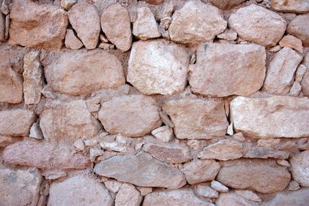 Old red stone wall background horizontal shotの写真素材