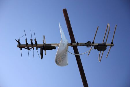 Old tv antenna isolated on blue skyの写真素材
