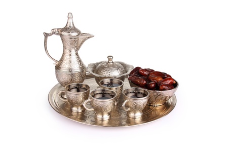 Antique silver pitcher and coffee cup set with dates in a tray isolated on a white background  Including clipping path の写真素材