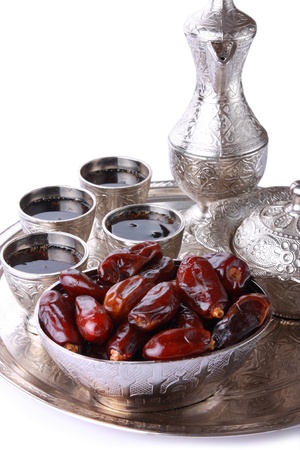 Antique silver pitcher and coffee cup set with dates in a tray isolated on a white background - vertical  Including clipping path の写真素材