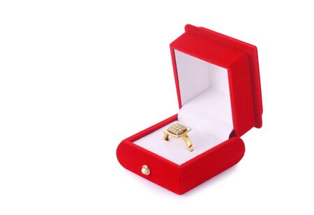 Golden ring in a red box isolated on white backgroundの写真素材