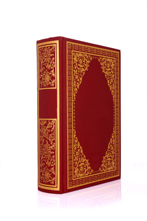 Old red book with gold color ornament on cover isolated on white clipping pathの写真素材