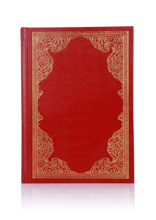 Old red book with gold color ornament on cover isolated on whiteの写真素材