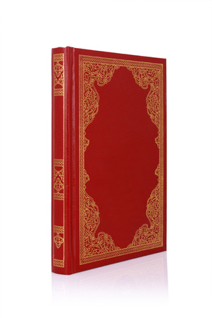 Old red book with gold color ornament on cover isolated on white の写真素材