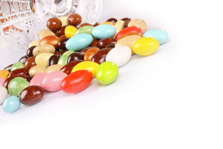 Candy beans with glass jar on white background with copyspaceの写真素材