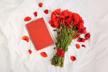 Bouquet of poppies and bookの写真素材