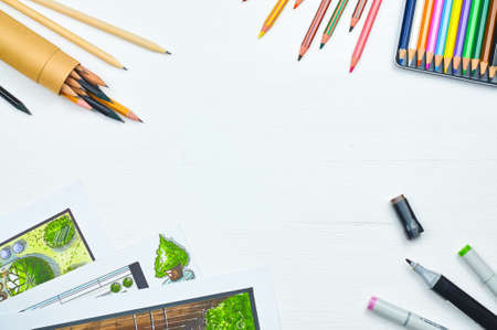 Top view of workplace of a designer with copyspace. Sketching tools: liners, markers, sketch images and pencils on a creative tabletop. Place for textの写真素材