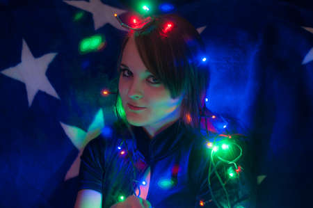 color light garland around her head on blue