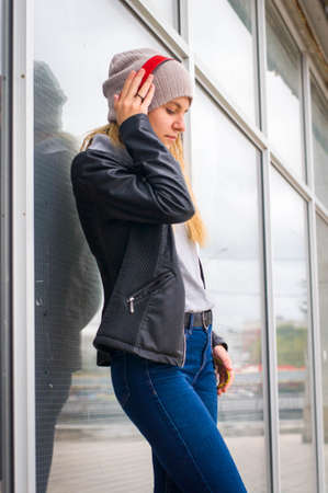 Young beautiful girl listening music in headphones