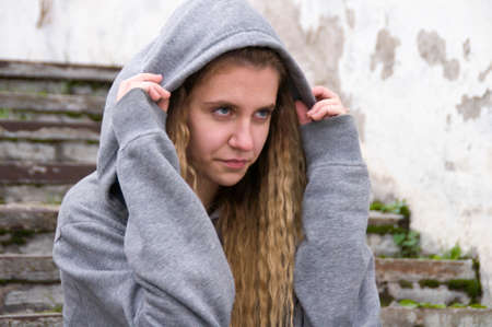 Sadness girl sitting on stairs in urban backgroundの写真素材