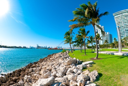 View of waterway used to enter Miami Seaport with city in the background and recreational park at the sideのeditorial素材