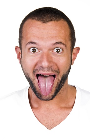 Portrait of a young man with his tongue, white backgroundの写真素材
