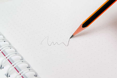 Zig zag, written in a graphite pencil on an empty padの写真素材