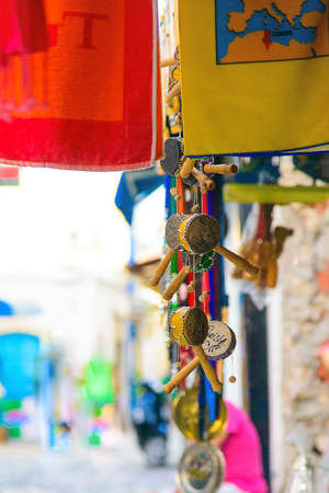 Small drums hanging with shawls on a street background of the city of Mahdia, Tunisia, multi-colored...