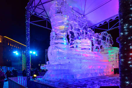 Russia, Moscow, January 07, 2020: festival Ice Moscow, Victory Park, ice figure of a steam locomotive with color illuminationのeditorial素材