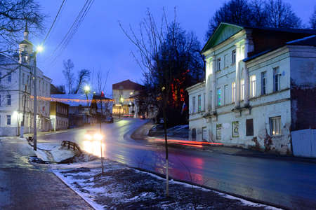 Russia, Borovsk, January 02, 2020: evening city street, a road going up between houses and treesのeditorial素材