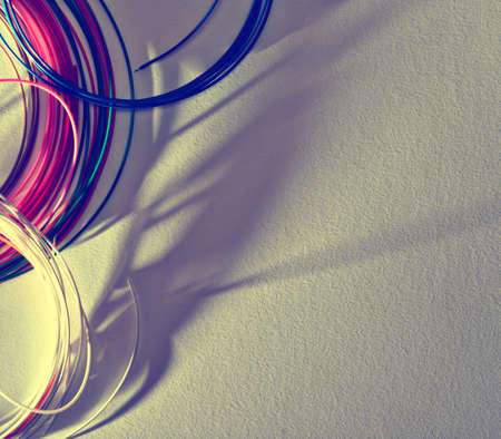 Background with skeins of colored wire, long shadows, texture of watercolor paper. Empty space for...