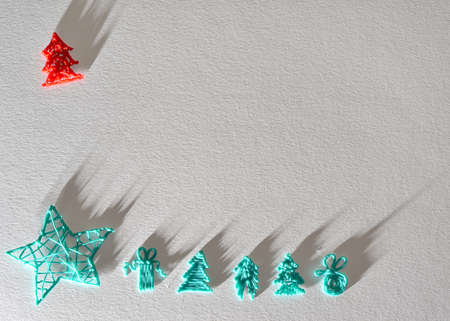 New Year and Christmas light background with green trees and a star, red tree with long shadows from bright light. Empty space for the inscription and text of congratulations, advertising, invitationsの写真素材