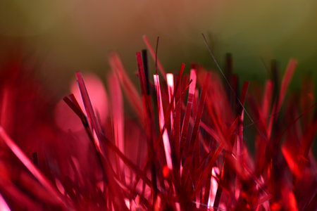 Abstract background red tinsel close-up macro, you can see separate strips of material, looks like a...