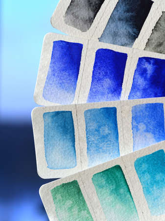 Color palette close-up watercolor on white paper, blue shades. On purple orchid background,...
