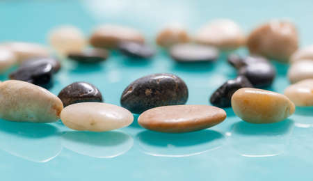 Two circles of stones, light and dark close-up. The distant shot is blurred, the stones in front...