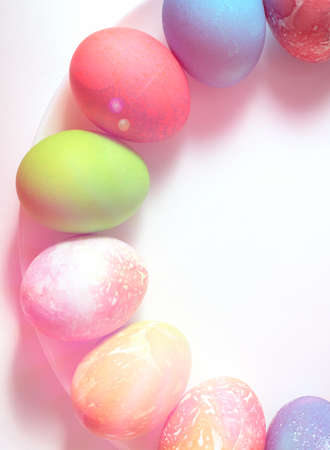 Colored eggs for Easter on a plate . White bottom of the plate. Blurred background.