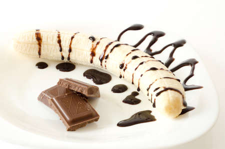 Banana split with chocolate bars on white backgroundの写真素材