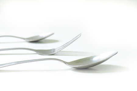 Stainless steel silver Spoon, Fork and small Spoon in line isolated on whiteの写真素材
