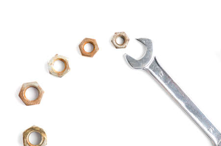Metal Wrench and many rusted nuts isolated on white backgroundの写真素材