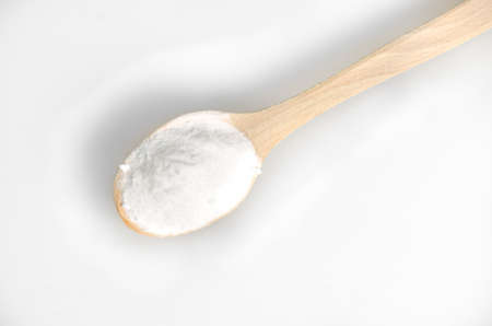 Baking soda in wooden spoon isolated on grey backgroundの写真素材