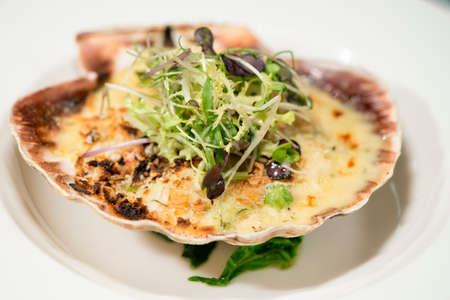 Fine Dining - Seafood - Baked Scallop On The Shell Placed On A Bed Of Spinach