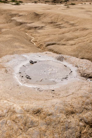 Romania, Buzau, Berca - Active Mud Volcanoes, Muddy Volcanoes Reservation in Mountains, View Landmark for Tourists, Landscape (unique geological phenomenon in Europe where the earth gas reaches the surface through hills making small Mud volcanoes)の写真素材