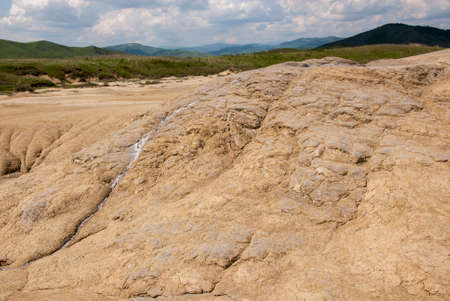 Romania, Buzau, Berca - Active Mud Volcanoes, Muddy Volcanoes Reservation in Mountains, View Landmark for Tourists, Landscape (unique geological phenomenon in Europe where the earth gas reaches the surface through hills making small Mud volcanoes)の写真素材