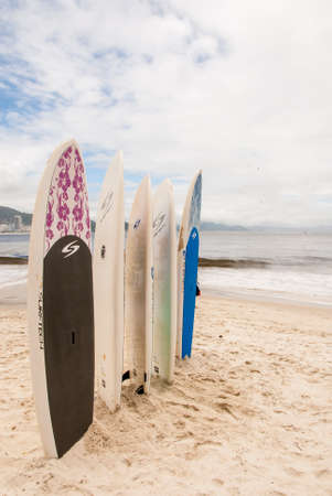 Surfboards standing upright in bright sun on the Copacabana Beach - Rio De Janeiro - Brazil - December 19th, 2013のeditorial素材