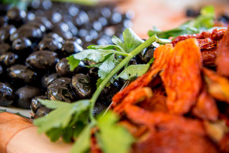 Dried tomatoes and olives in the fresh food marketplace of Cefalu, Italyの写真素材