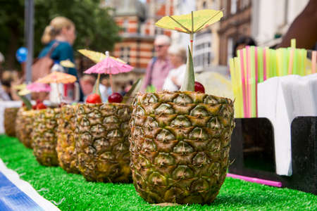 Fresh Tropical Pina Colada cocktail served in a pineapple - Summer Food Street Marketの写真素材