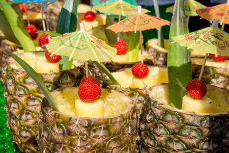 Fresh Tropical Pina Colada cocktail served in a pineapple - Summer Food Street Market