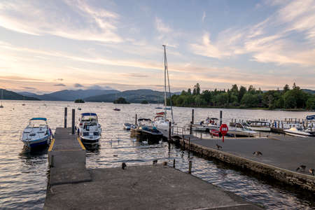 Bowness-on-Windermere, England - August 4, 2018: Panoramic view of Moored Yachts as the Sun Sets over Lake WIndermereのeditorial素材