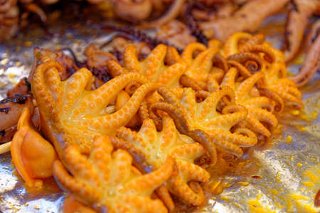 Thai food. Grilled seafood on sticks on food street market - Bangkok, Thailandの写真素材