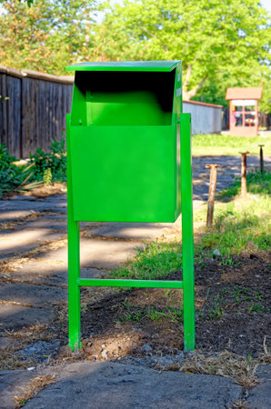 Street green painted waste bin in city parkの写真素材