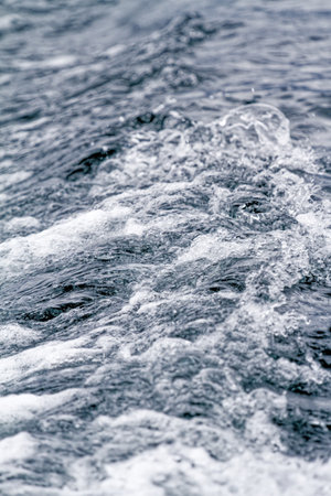 Boat Wave ocean trace on blue sea fresh water background. Deep ocean water surface trail bubble foamingの写真素材