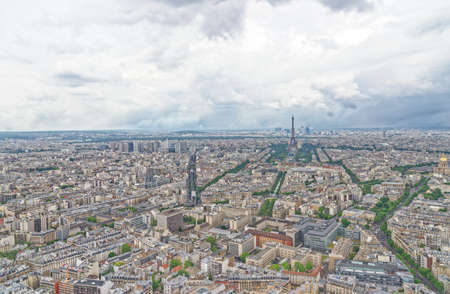 View over Paris, looking towards the Eiffel Tower and La Defense, from the observation deck at the top of the Tour Montparnasse, Paris, France.の写真素材