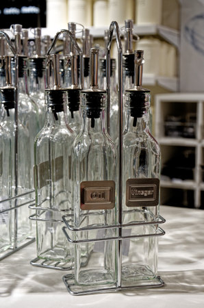 Empty oil and vinegar bottles for condiment - Tableware set of glass olive oil and vinegar bottlesの写真素材