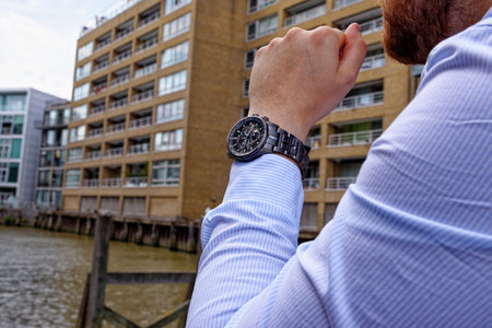 Young man in China Wharf London wearing fashion watch - London, United Kingdom, 1st of June 2019のeditorial素材