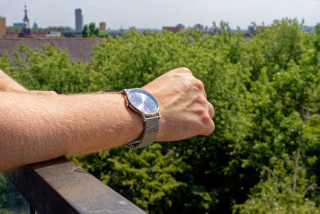 Young man relaxing in balcony wearing fashion watch - London, United Kingdom, 1st of Juneのeditorial素材