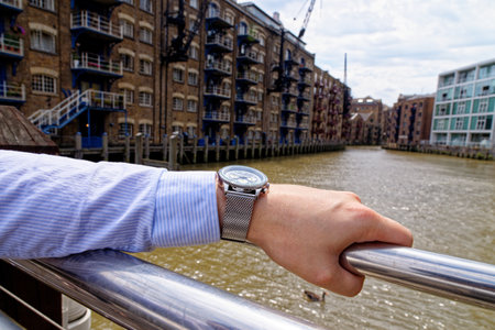 Young man in China Wharf London wearing fashion watch - London, United Kingdom, 1st of June 2019のeditorial素材