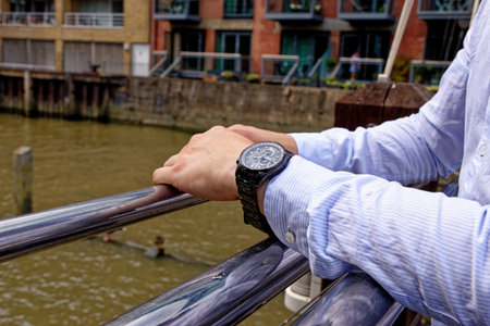 Young man in China Wharf London wearing fashion watch - London, United Kingdom, 1st of June 2019のeditorial素材