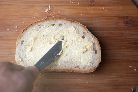 Bread with butter on a cutting board